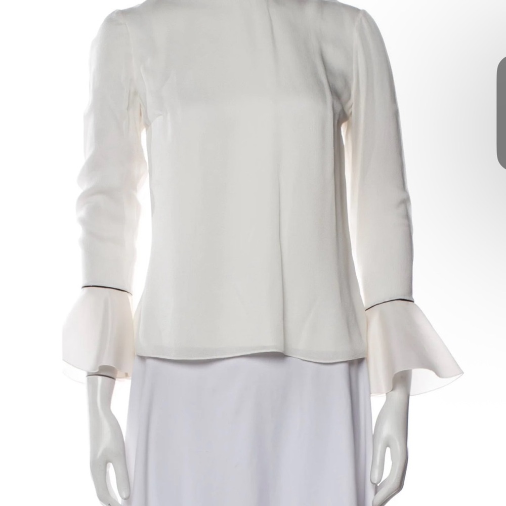 Shick Silk boatline neck blouse with  long ruffled sleeves .